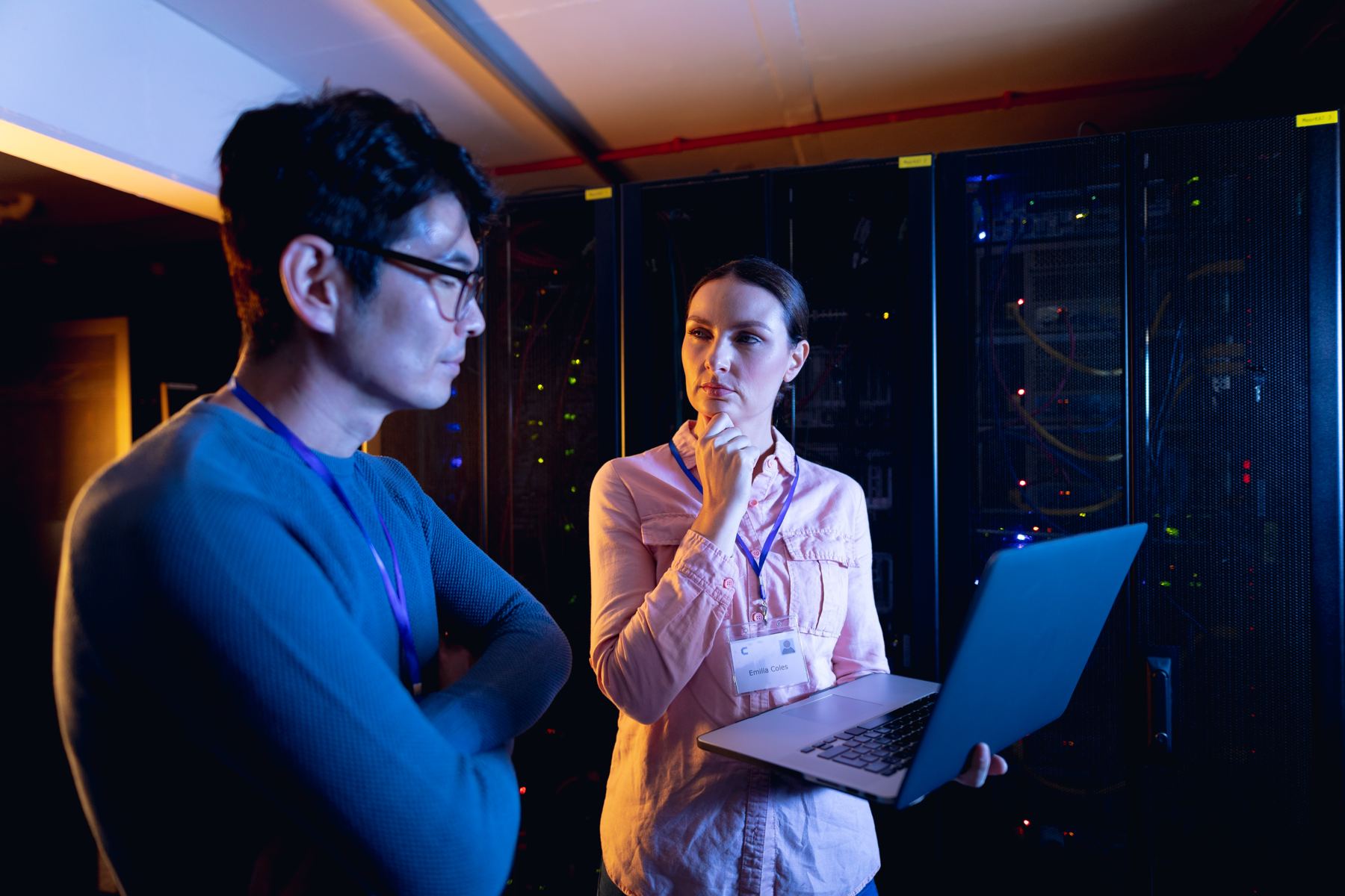 Technicians coordinating work in a server room