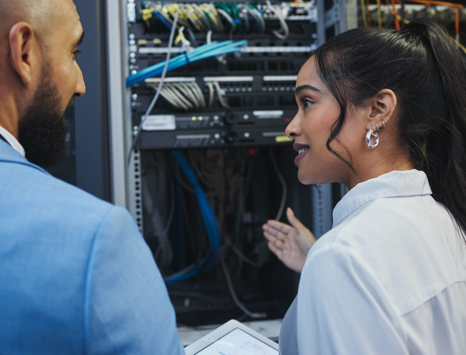 Client and technician reviewing a network rack